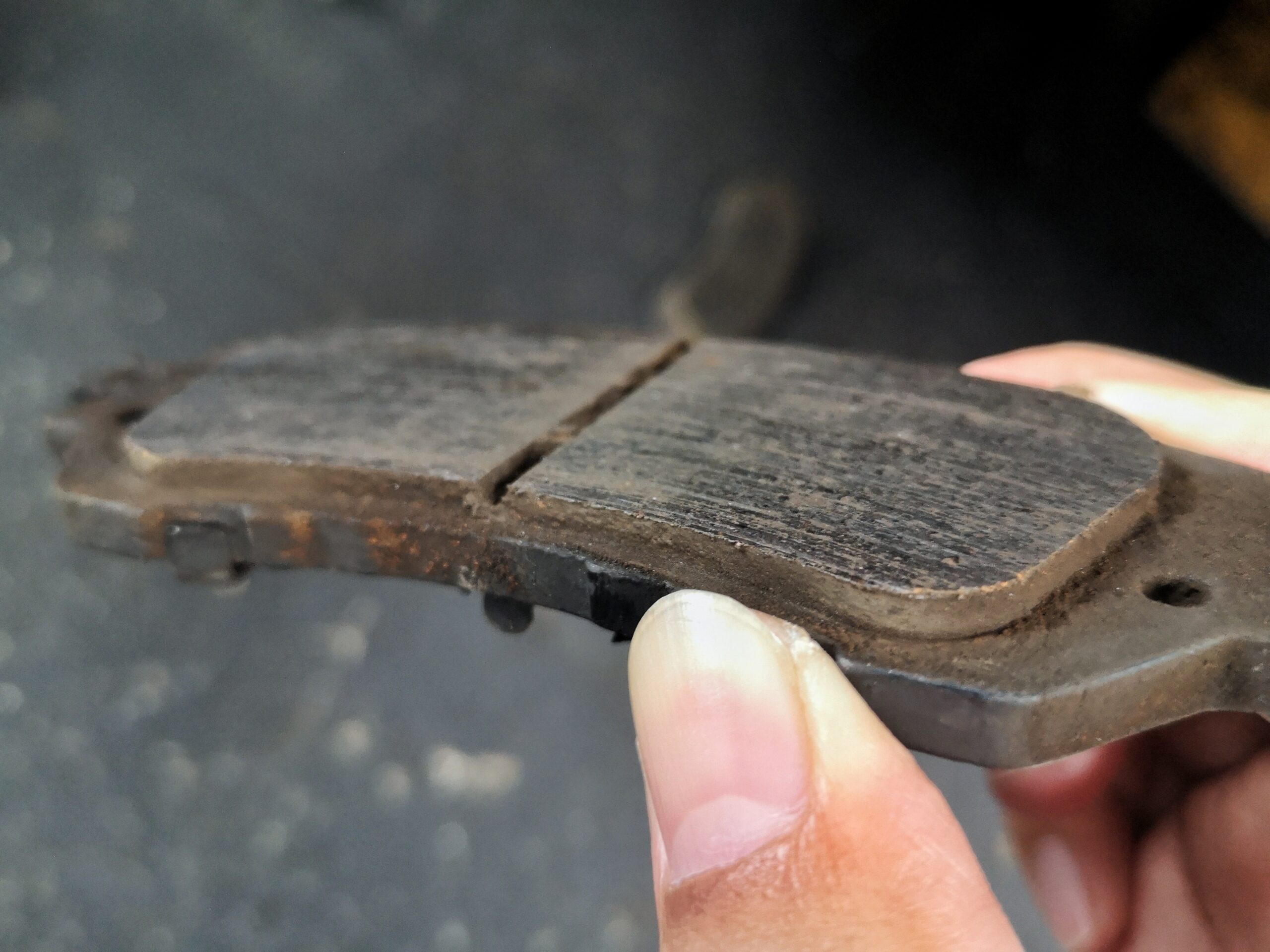 Mechanic inspecting brake pads